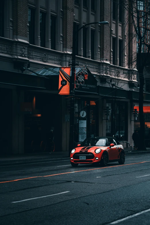 a red sports car driving down a city street, by Austin English, pexels contest winner, hypermodernism, black and orange, mini, vancouver, square