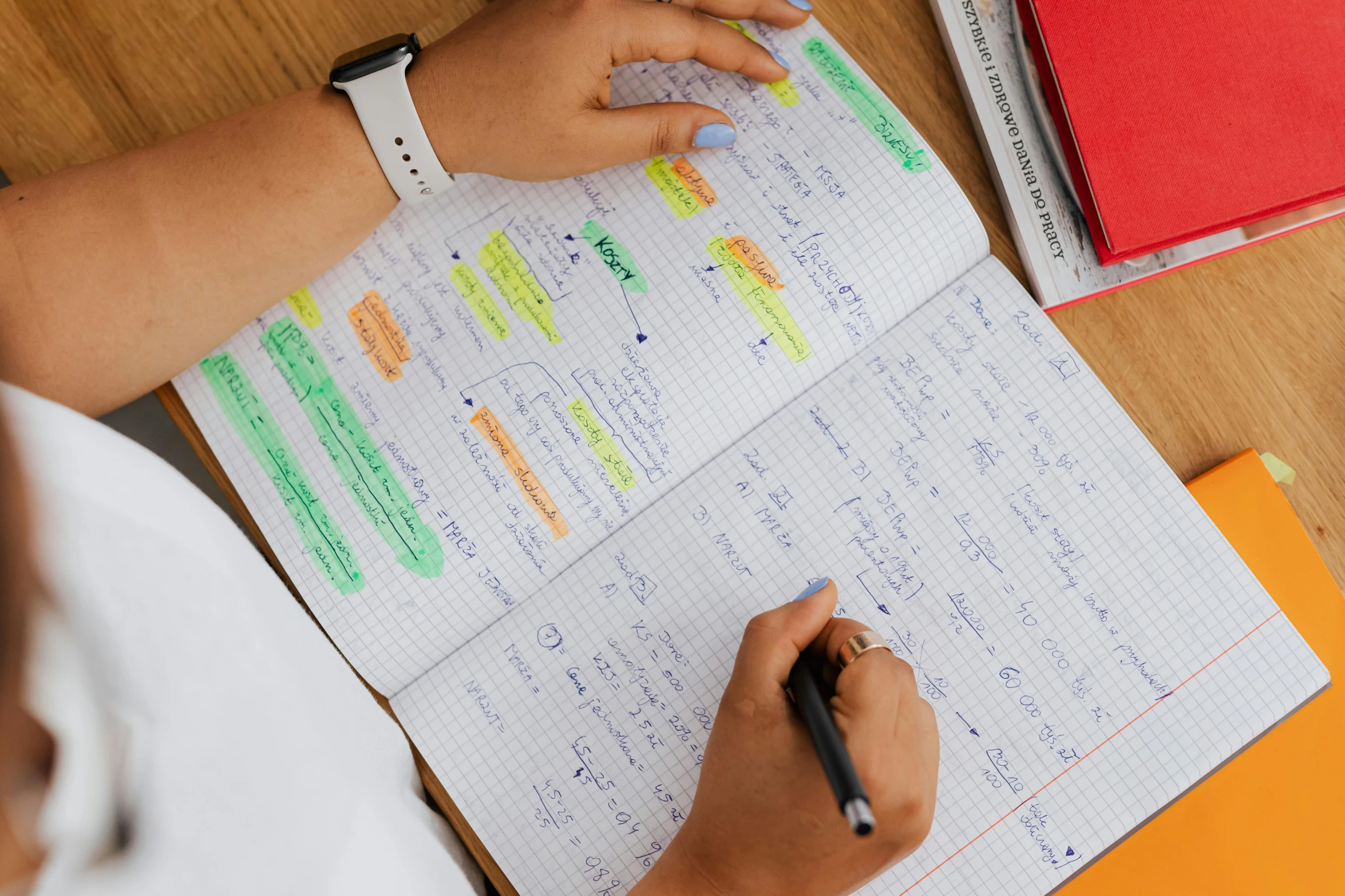 a person sitting at a table writing on a piece of paper, textbooks, idealised, holding notebook, with notes