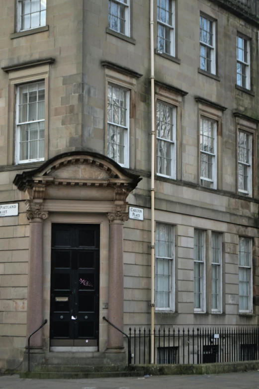 a tall building sitting on the side of a street, inspired by Gawen Hamilton, doorway, scottish style, private academy entrance, old apartment