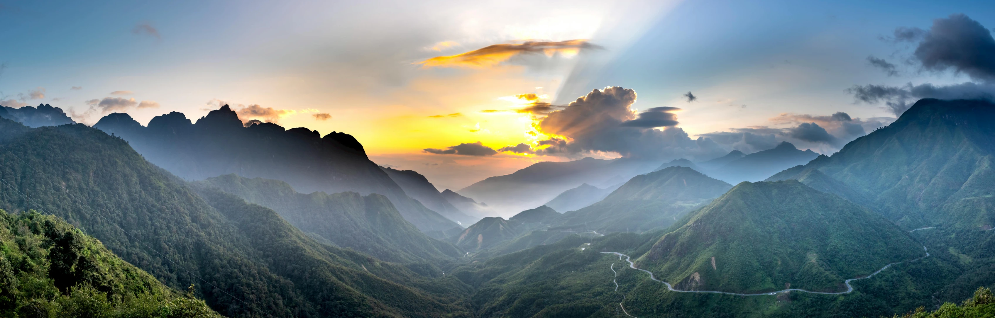 the sun shines through the clouds over the mountains, a matte painting, by Reuben Tam, pexels contest winner, vietnam, sunset panorama, mountain pass, bright sunny day