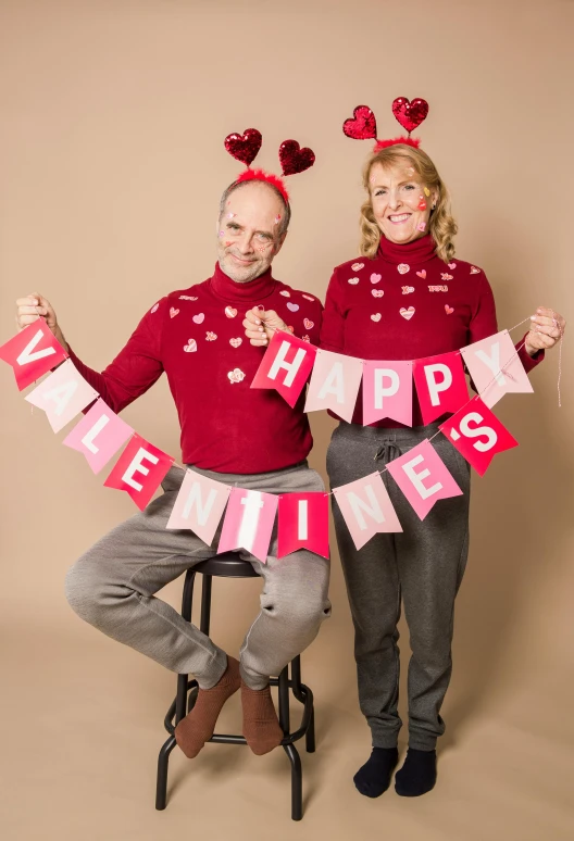 a couple of people that are posing for a picture, by Valentine Hugo, happening, wearing festive clothing, lynn skordal, official store photo, falling hearts