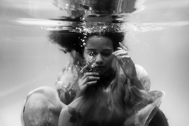 a black and white photo of a woman under water, inspired by Gordon Parks, tessa thompson, saatchi art, african american young woman, dreamy art