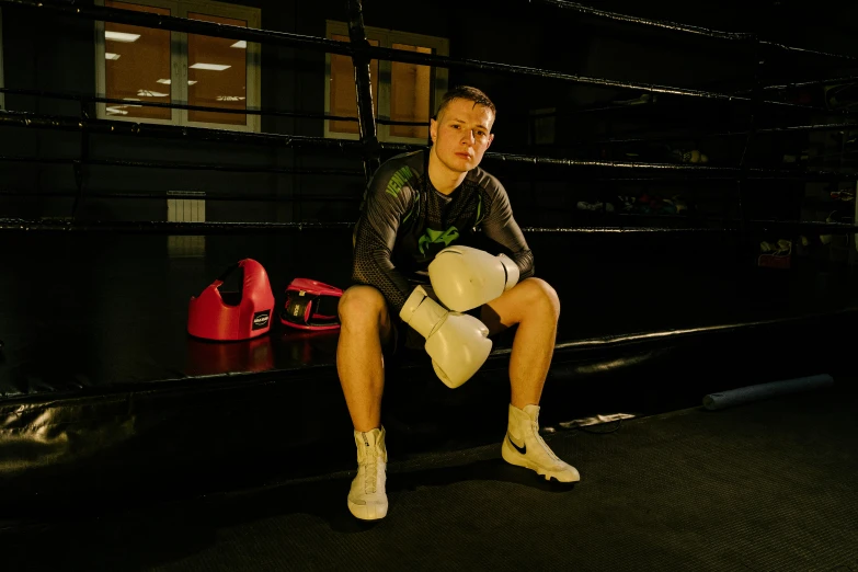 a man sitting on a bench in a boxing ring, liam brazier, profile image
