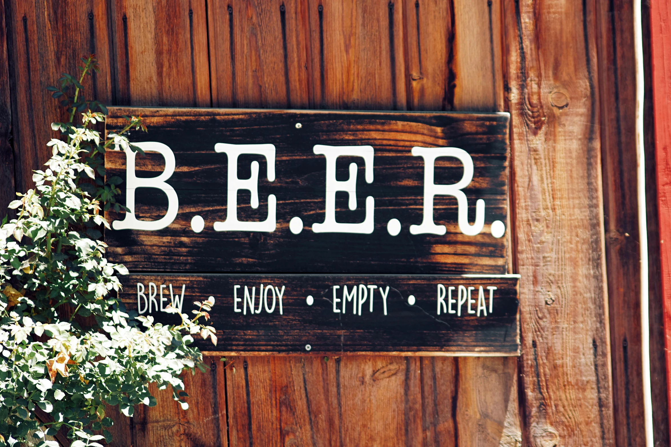 a wooden sign sitting on the side of a building, by Tuvia Beeri, unsplash, beers on the table, dwell, barn, scrapbook