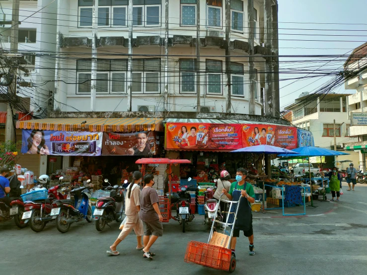 a group of people walking down a street, patiphan sottiwilai, lots of signs and shops, slide show, thumbnail