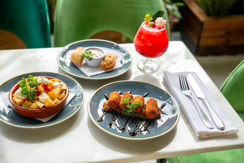 a table topped with three plates of food, las pozas, drinks, square, colourful