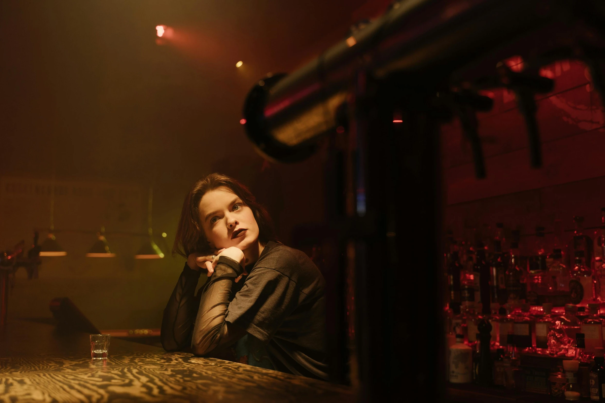 a woman sitting at a bar with a drink in her hand, a portrait, inspired by Nan Goldin, unsplash, renaissance, rachel weisz, nightclub, miss aniela, taken in the early 2020s