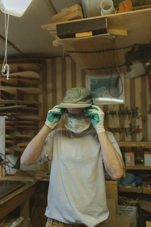 a man that is standing in a room, green visor, craftsmanship, dust mask, thumbnail