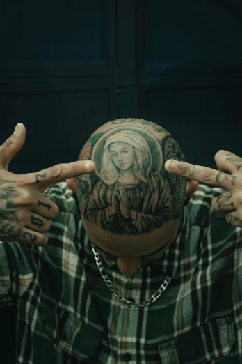 a man with tattoos covering his head with his hands, a tattoo, inspired by Mathieu Le Nain, jayson tatum as mother mary, still from a music video, bald patch, chinnese mafia