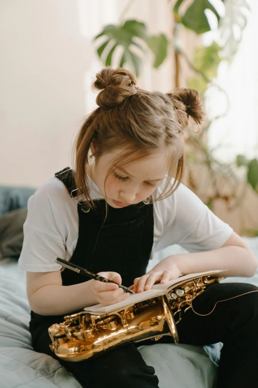 a little girl sitting on a bed with a saxophone, pexels contest winner, writing on a clipboard, focused on her neck, idealised, thumbnail