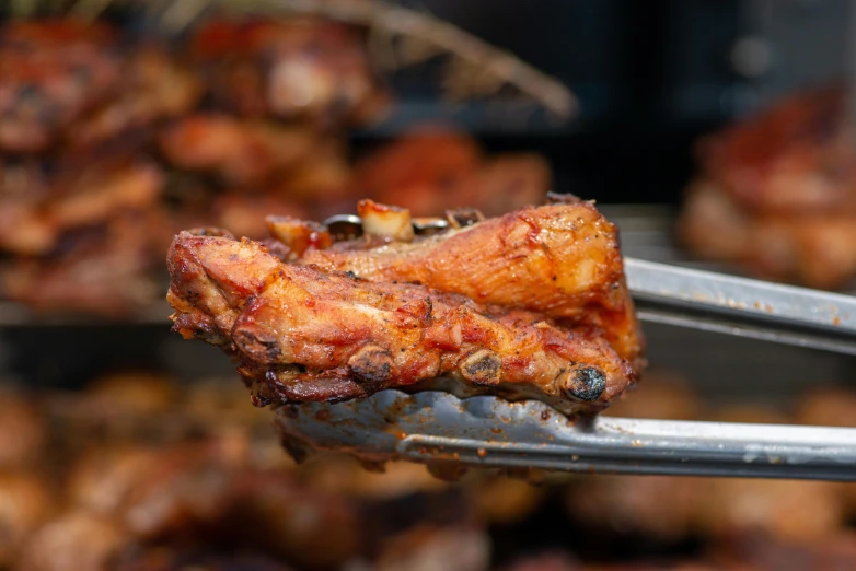 a close up of a fork with meat on it, by Matt Cavotta, pexels contest winner, hurufiyya, four wings, smokey cannons, glazed, 5 feet away