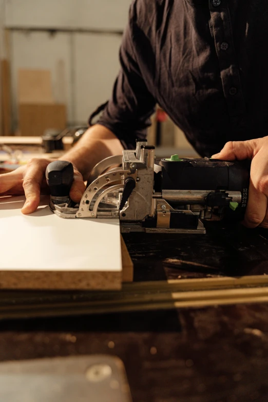 a man using a circular saw to cut a piece of wood, pexels contest winner, arbeitsrat für kunst, 9 9 designs, smooth panelling, hands on counter, performance