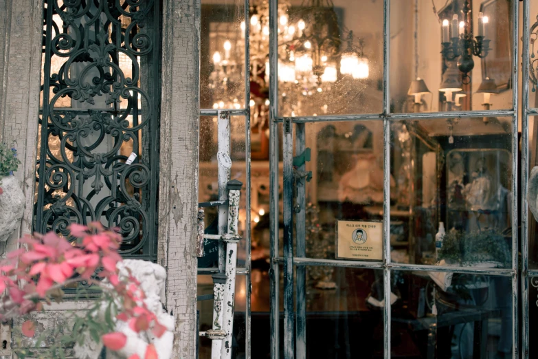 a teddy bear sitting in front of a glass door, a photo, unsplash, art nouveau, flower shop scene, wrought iron architecture, with ornate jewelled, french provincial furniture