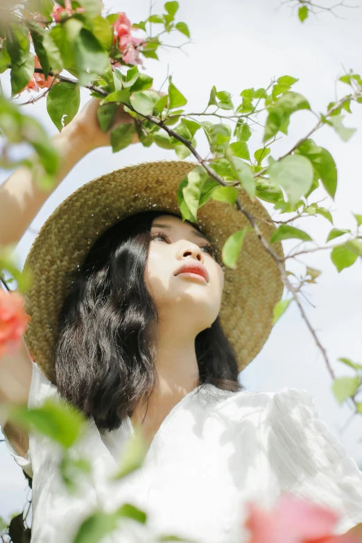 a woman wearing a straw hat in a garden, inspired by Ren Hang, trending on pexels, apple tree, ulzzang, looking upwards, clean image