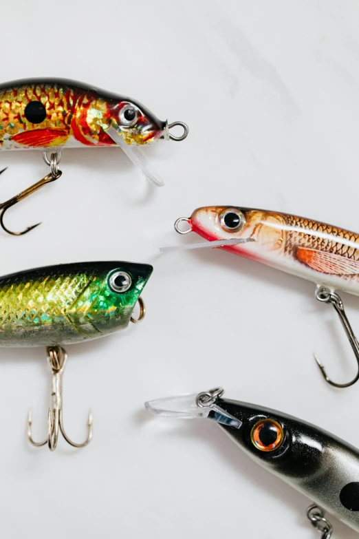 a number of fishing lures on a white surface, by Nina Hamnett, trending on pexels, photorealism, rapids, flashing lights, good face, detailed product shot