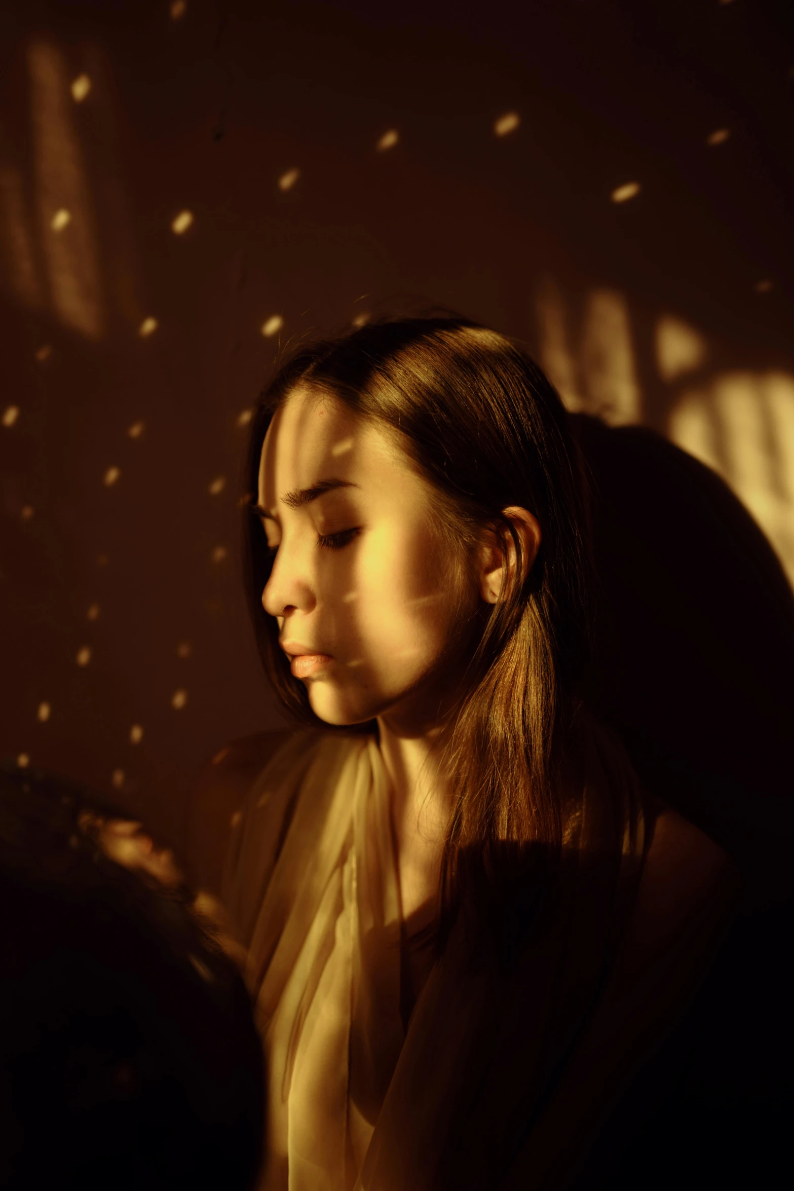 a woman sitting in a chair with her eyes closed, inspired by Elsa Bleda, pexels contest winner, light and space, warm glow from the lights, portrait of depressed teen, medium format. soft light, starry