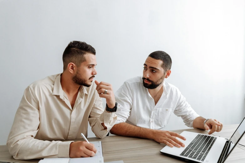 two men sitting at a table with a laptop, pexels contest winner, wondering about others, background image, professional image, brown