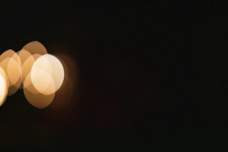 a couple of lights that are in the dark, an album cover, by Attila Meszlenyi, unsplash, three moons, still frame from a movie, 70mm film screenshot, telephoto long distance shot