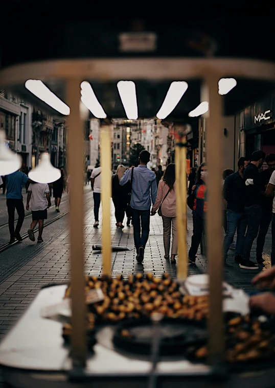 a group of people walking down a street, inspired by Modest Urgell, unsplash contest winner, food stall, lights, square, high resolution photo