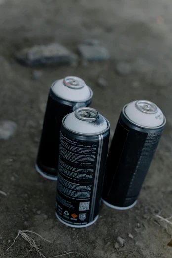 three cans of soda sitting on the ground, a picture, unsplash, graffiti, dark. no text, drones, pbr materials, pack