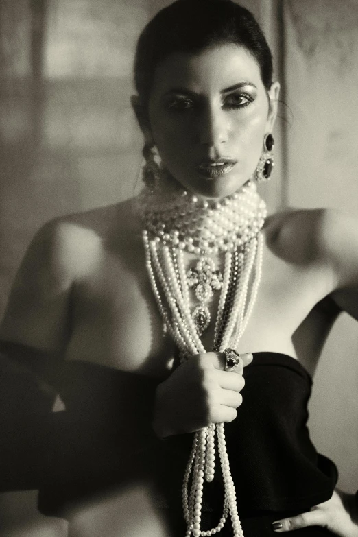 a black and white photo of a woman wearing pearls, inspired by George Hurrell, renaissance, pr shoot, ((chains)), middle eastern, glamourous cosplay