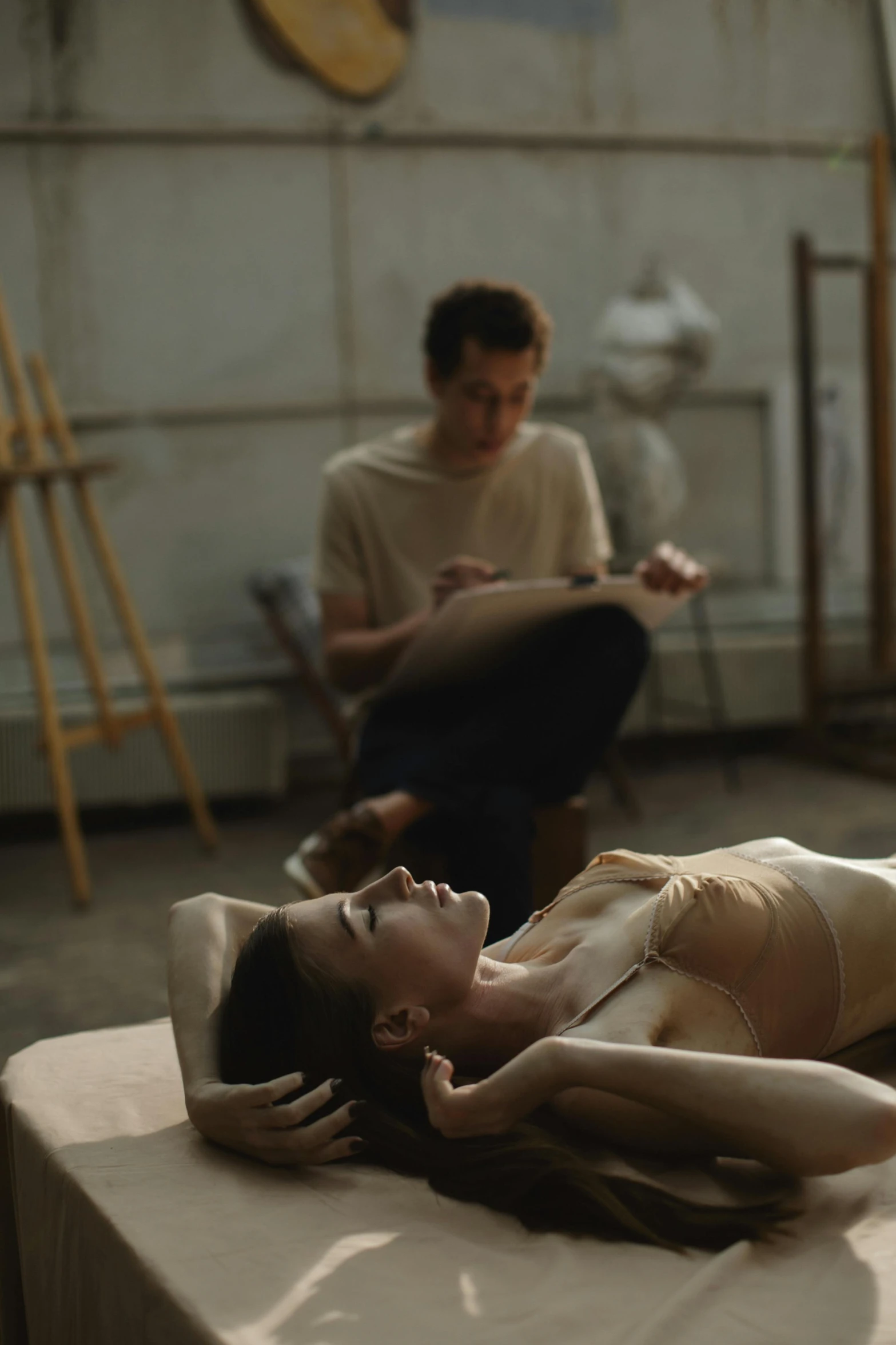 a woman laying on top of a bed next to a man, by artist, pexels contest winner, visual art, film movie still, in a studio, art student, ignant