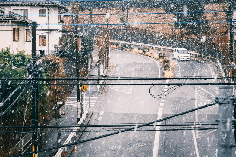 a street filled with lots of traffic next to tall buildings, inspired by Hasui Kawase, unsplash contest winner, ukiyo-e, in an ice storm, wires hanging across windows, countryside in japan, photo”