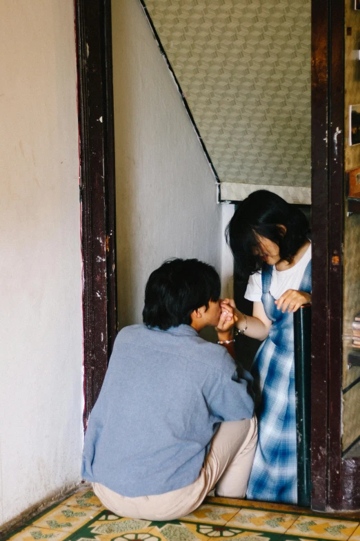 a couple of people sitting on the ground in front of a door, pexels contest winner, shin hanga, shy looking down, playing, taiwan, kissing together