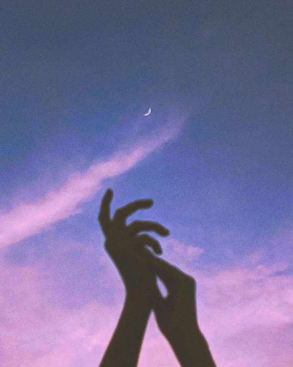 a person reaching up to a crescent in the sky, an album cover, trending on pexels, aestheticism, ☁🌪🌙👩🏾, pastel', single pair of hands, purple - tinted