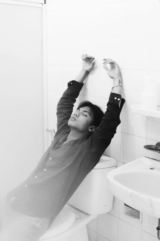 a man laying on top of a toilet in a bathroom, a black and white photo, by Matteo Pérez, young prince, dabbing, nishihara isao, profile image