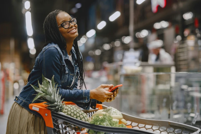 a woman sitting in a shopping cart looking at her phone, pexels, fresh food market people, avatar image, african american woman, cinematic image