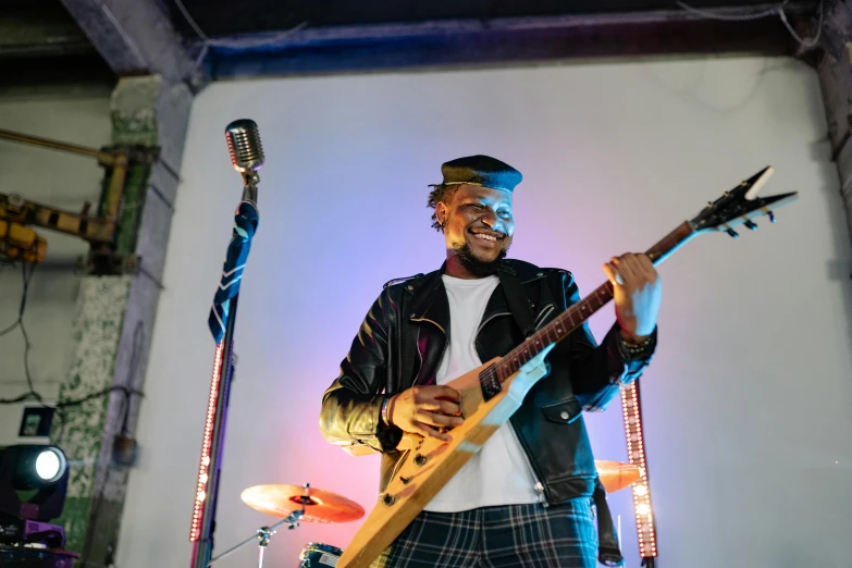 a man that is standing up with a guitar, pexels contest winner, brown skin man with a giant grin, lightening, rectangle, band playing