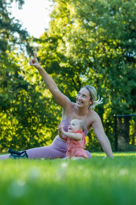 a woman sitting on top of a lush green field, families playing, fitness, profile image, square
