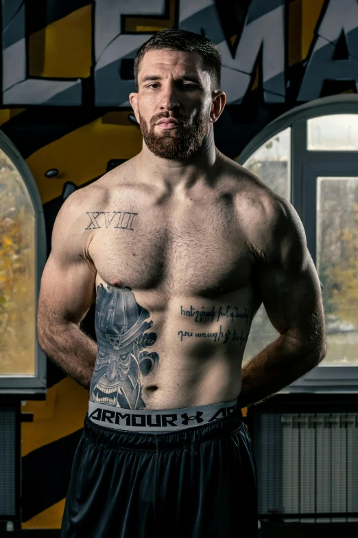 a man with tattoos standing in front of a window, a tattoo, inspired by Alexey Merinov, in a boxing ring, promo photo, square, armour