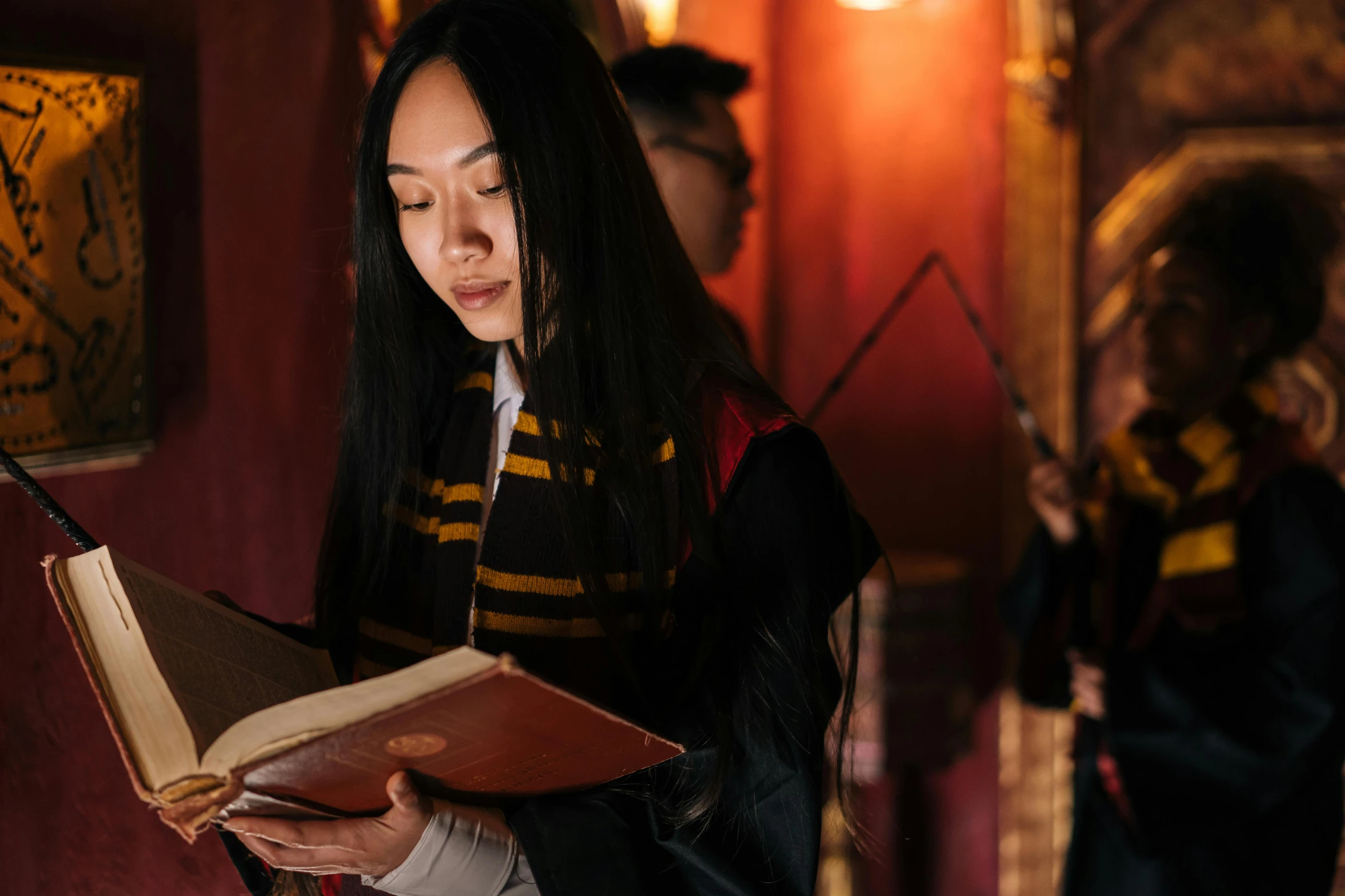 a woman reading a book in a room, inspired by Hermione Hammond, pexels contest winner, dressed as a wizard, a young asian woman, hogwarts 2 0 7 7, concert