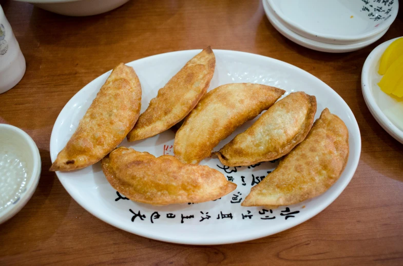 a close up of a plate of food on a table, mingei, battered, fan favorite, brown, image