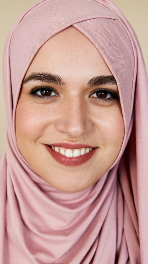 a smiling woman wearing a pink hijab, inspired by Maryam Hashemi, shutterstock, full face close up portrait, olive skin color, h3h3, face photo