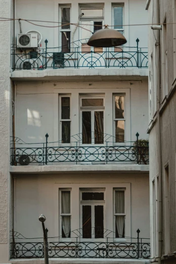 a couple of buildings that are next to each other, inspired by André Kertész, pexels contest winner, art nouveau, balcony door, a quaint, tom, white buildings