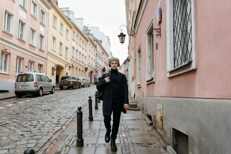 a man walking down a cobblestone street, by Julia Pishtar, pexels contest winner, bauhaus, russian clothes, wearing a beret, timothee chalamet, full body image