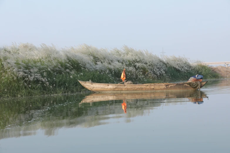 a person in a boat on a body of water, by Jan Tengnagel, hurufiyya, river delta, maintenance photo, li zixin, anthropology photo”