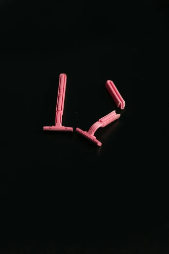 a pair of pink scissors laying on top of a black surface, by Albert Welti, conceptual art, detailed glowing red implants, square jaw-line, miniature product photo, hegre