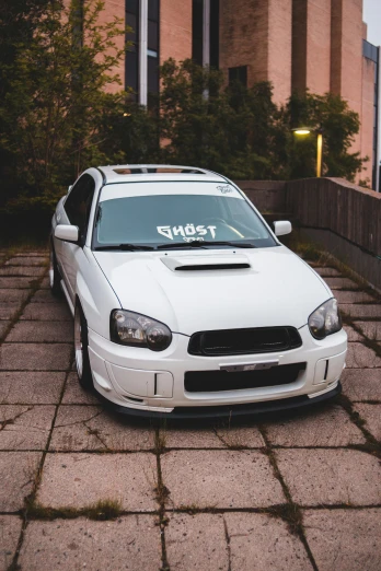 a white car parked in front of a building, inspired by An Gyeon, pexels contest winner, ghost mask, subaru, tuning, 2 0 0 0 s