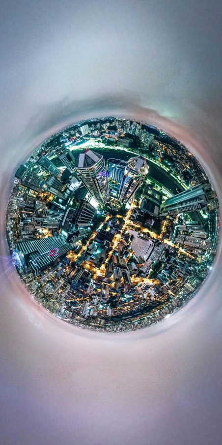 an aerial view of a city at night, inspired by Beeple, unsplash contest winner, ((fish eye)), glass ball, ultrawide lens”, bird\'s eye view