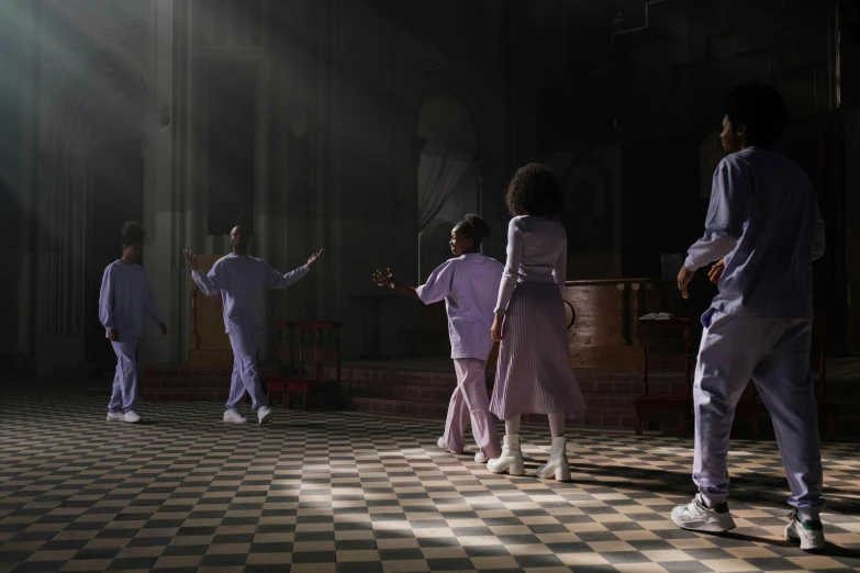 a group of people standing on top of a checkered floor, an album cover, inspired by Carrie Mae Weems, pexels contest winner, scene set in a church, wearing a purple sweatsuit, dance scene, [ theatrical ]