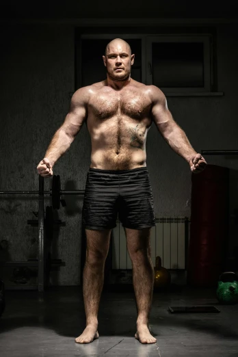 a man standing in a gym holding a bar, a portrait, by Paul Bird, pexels contest winner, full human hairy body, thrusters, sean mcloughlin, full frontal portrait