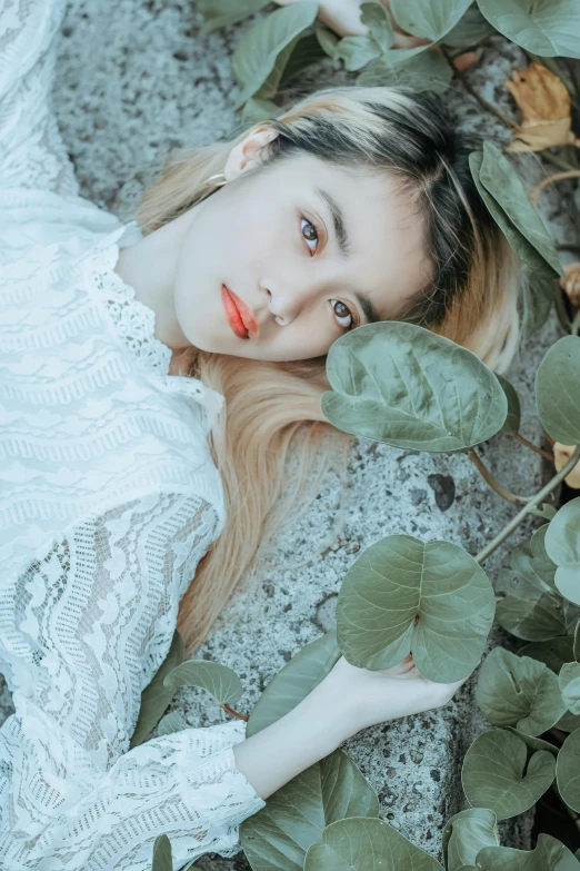 a woman laying on the ground surrounded by leaves, aestheticism, portrait of kpop idol, with a white complexion, red contact lenses, sea - green and white clothes