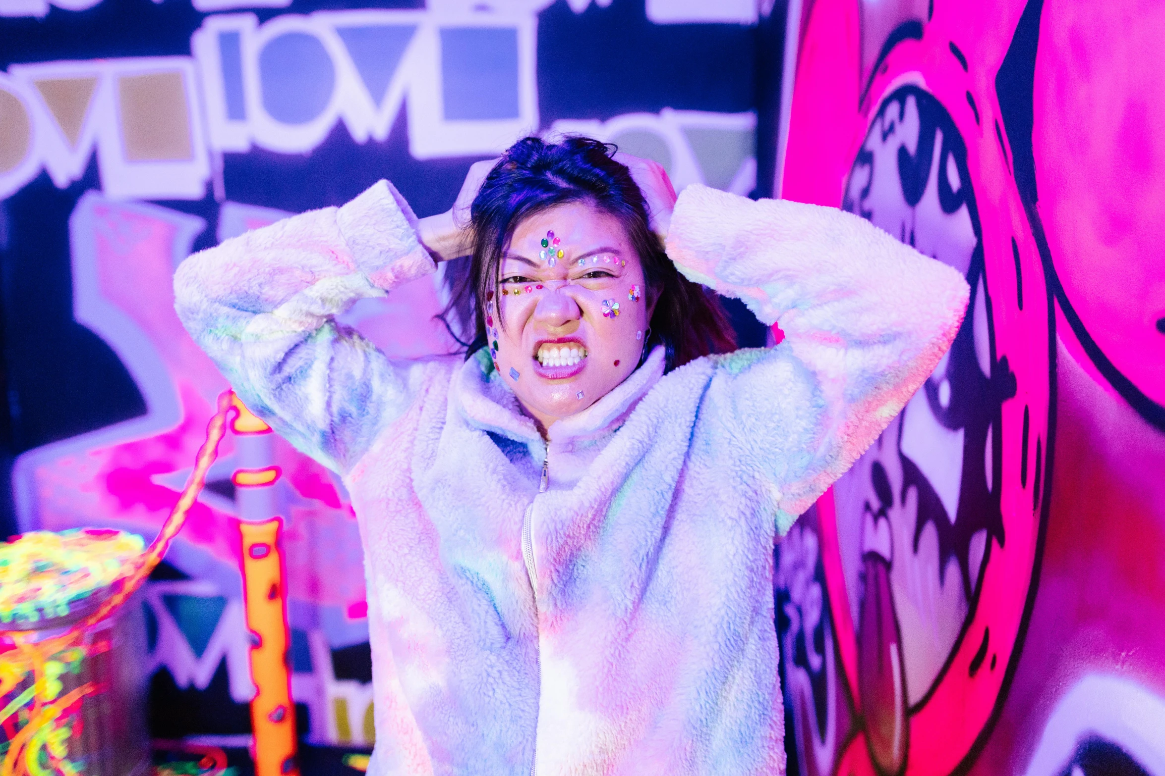 a woman standing in front of a wall covered in graffiti, graffiti, woman in a sheep costume, blacklight reacting, kpop, lazertag