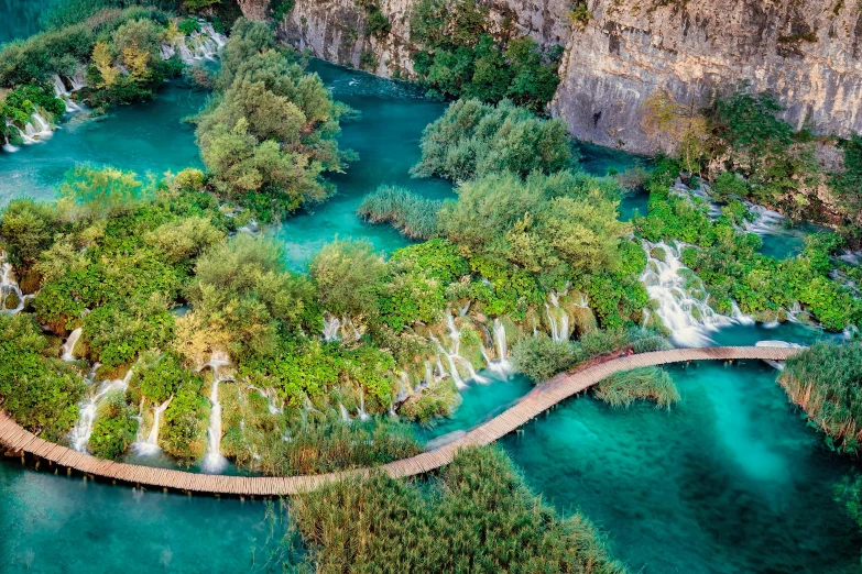 an aerial view of the plitvic waterfall in croatia, pexels contest winner, hurufiyya, avatar image, bridge over the water, thumbnail, terraced orchards and ponds