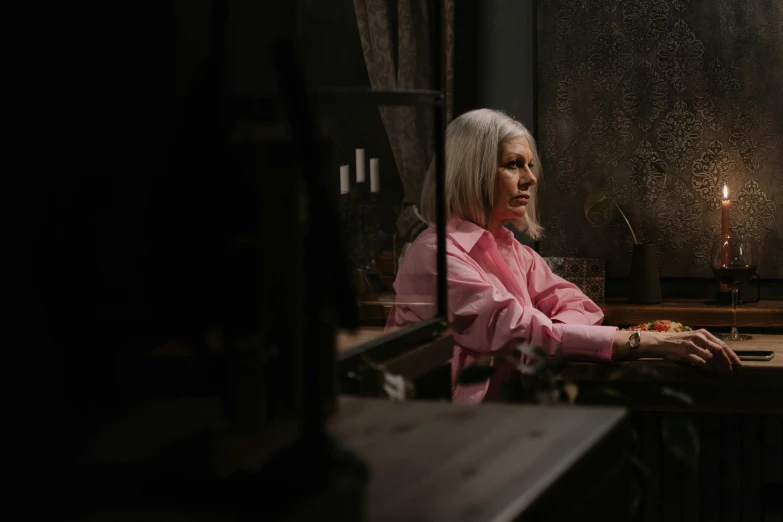 a woman sitting at a table with a glass of wine, a character portrait, inspired by Elsa Bleda, pexels contest winner, white haired, trapped in the backrooms, looking at monitor, pink