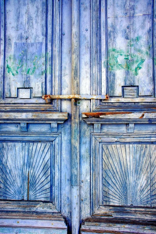 a close up of two wooden doors on a building, an album cover, pexels contest winner, renaissance, shades of blue, painted metal, airy colors, scratched